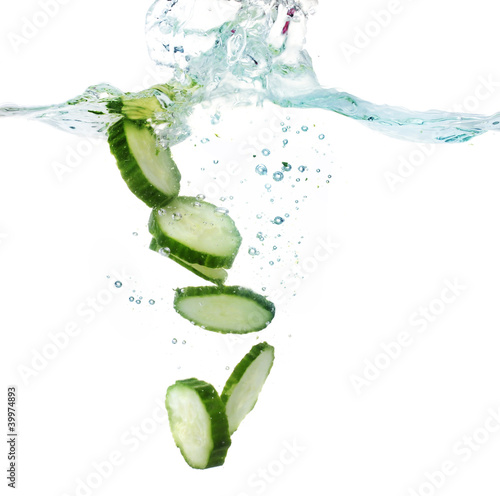 fresh sliced cucumber in water isolated on white