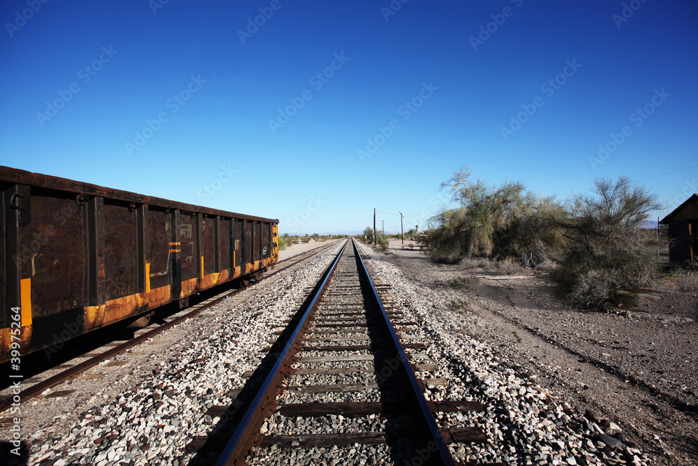 Fototapeta premium View of Train Tracks, Southwestern US, with Coal Car on Siding