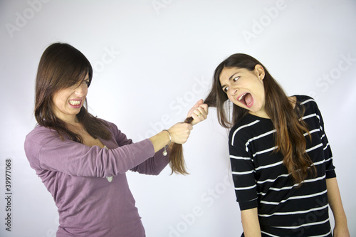 girl pulling the hair of her friend