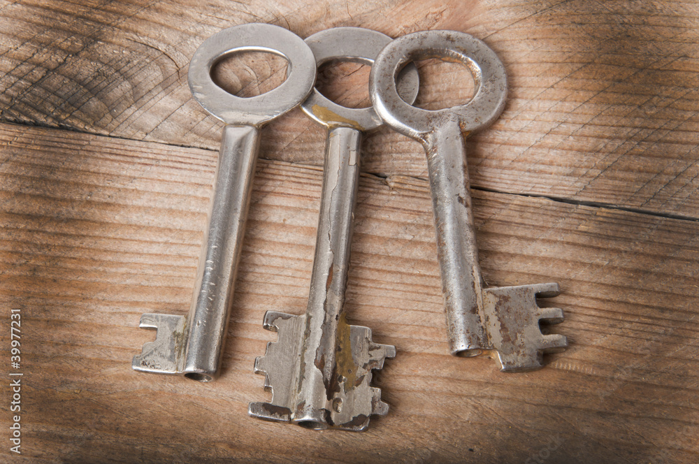 the old keys on a wooden background the old keys on a wooden background