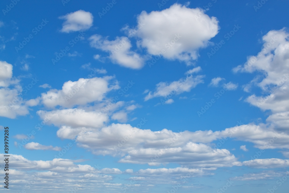 A blue sky and fluffy clouds.