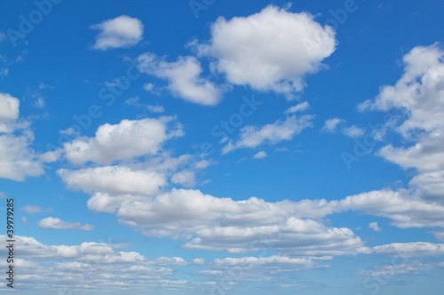 A blue sky and fluffy clouds.