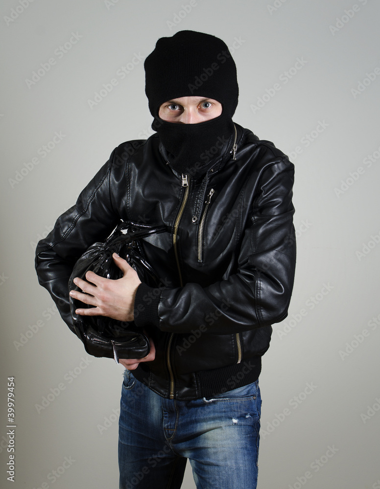 Portrait of male burglar with a handbag. Portrait of male burglar with a handbag.