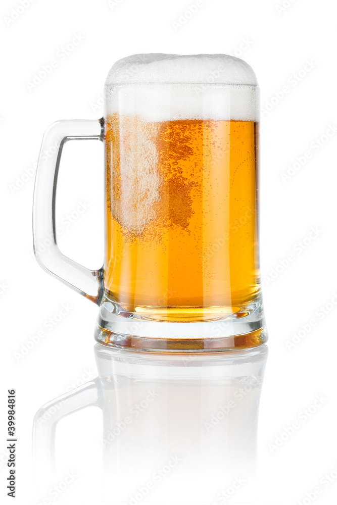 Pouring fresh beer into mug isolated over a white background Pouring fresh beer into mug isolated over a white background