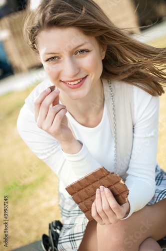 Young woman eating chocolate