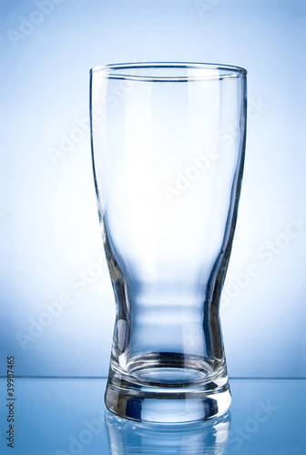 Empty glass glass for drinks on a blue background