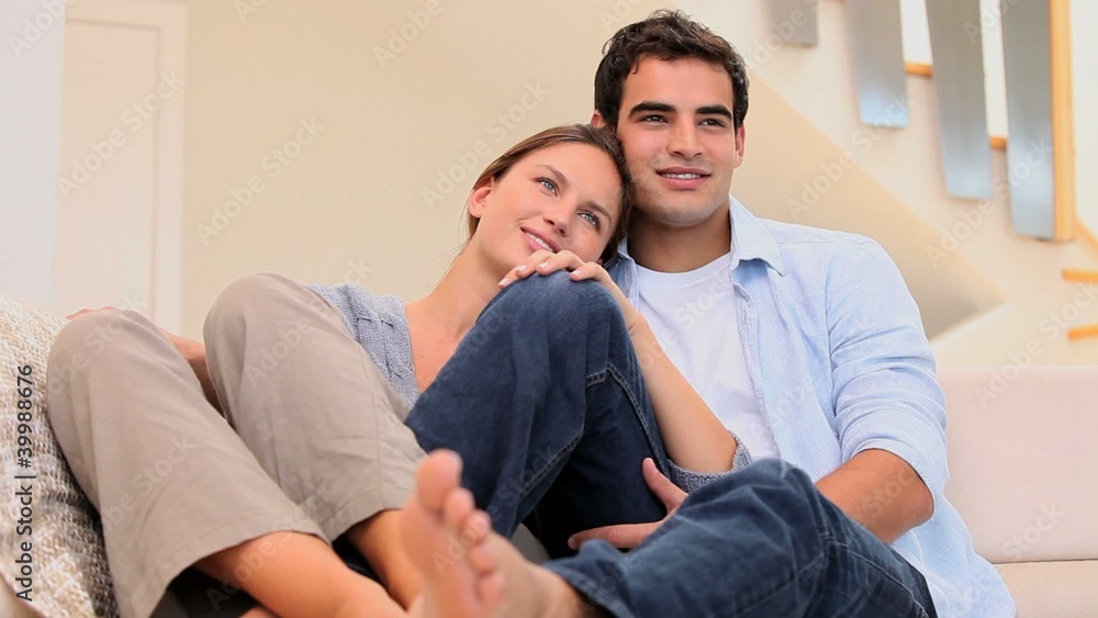 Couple embracing each other on a sofa Couple embracing each other on a sofa