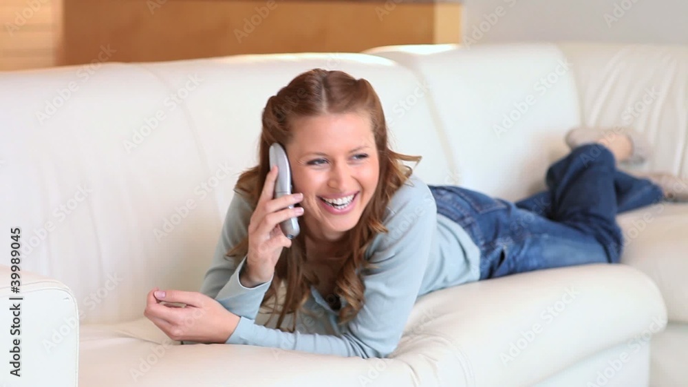 Young happy woman talking on the phone Young happy woman talking on the phone