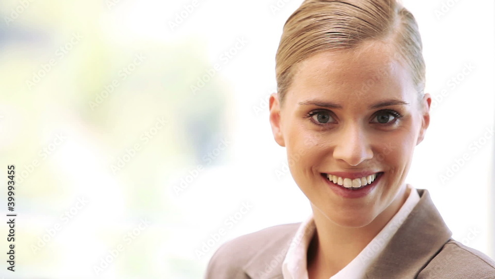 Businesswoman smiling while standing upright Businesswoman smiling while standing upright