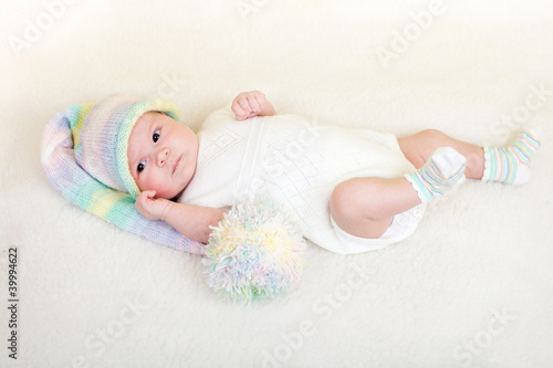 infant baby weared funny hat lying on a blanket