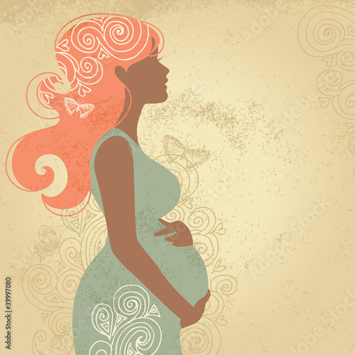 Silhouette of pregnant woman in flowers