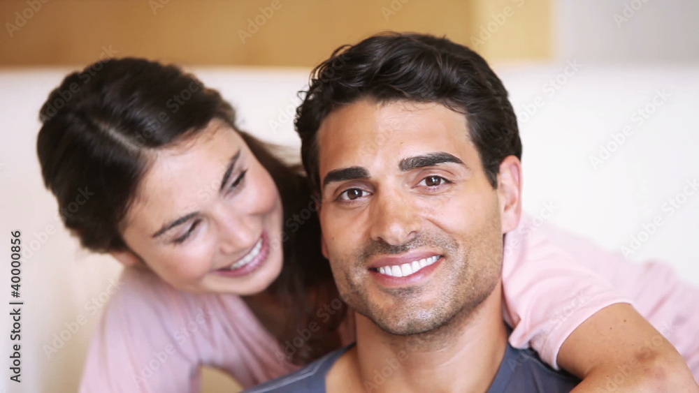 Smiling woman hugging her boyfriend Smiling woman hugging her boyfriend