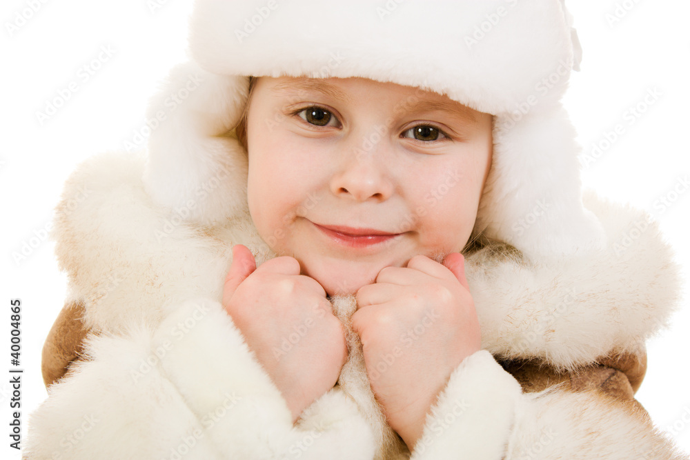 A girl in a fur coat and hat smiling on white background. A girl in a fur coat and hat smiling on white background.