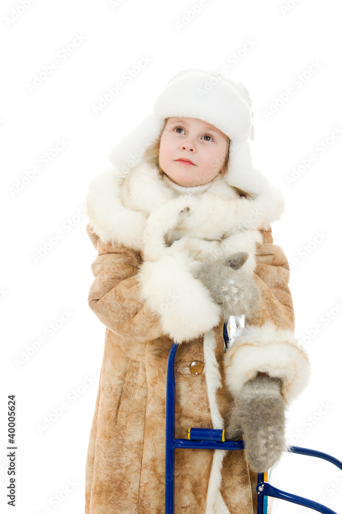 The girl in warm clothes with a sledge surprise looking up The girl in warm clothes with a sledge surprise looking up