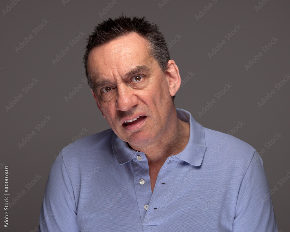 Middle Age Man Pulling Unhappy Face and Grimacing Middle Age Man Pulling Unhappy Face and Grimacing