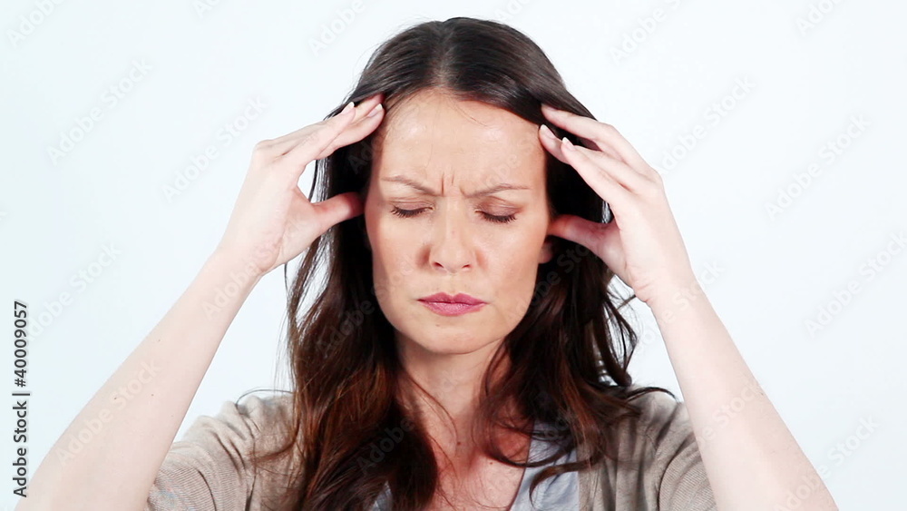 Brunette woman massaging her temples Brunette woman massaging her temples