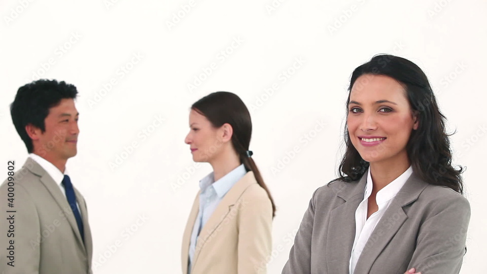 Businesswoman posing with her colleagues talking Businesswoman posing with her colleagues talking