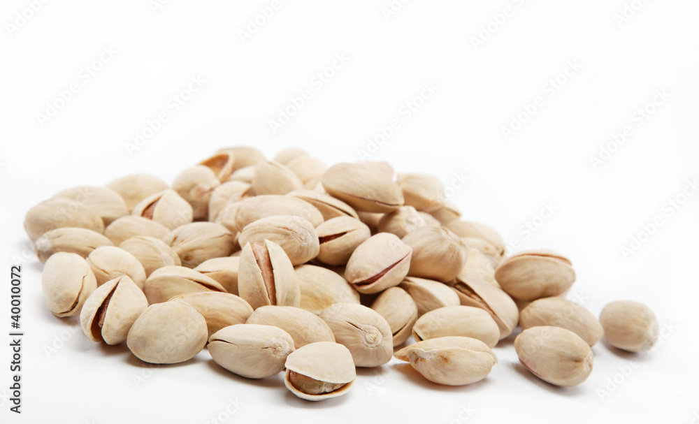 pistachios heap against white background pistachios heap against white background