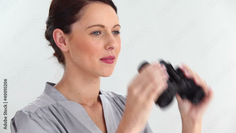 Beautiful woman looking through binoculars Beautiful woman looking through binoculars