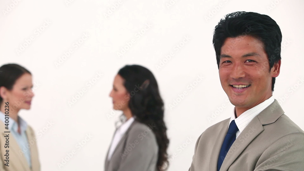 Businessman laughing in front of his colleagues Businessman laughing in front of his colleagues