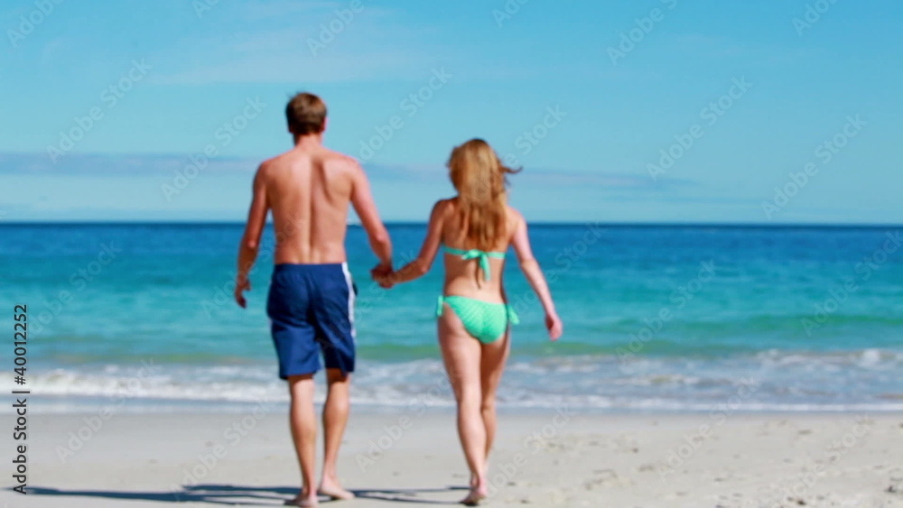 Couple holding their hands while walking Couple holding their hands while walking