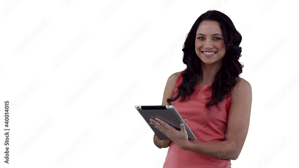 Woman smiling as she uses a tablet pc Woman smiling as she uses a tablet pc