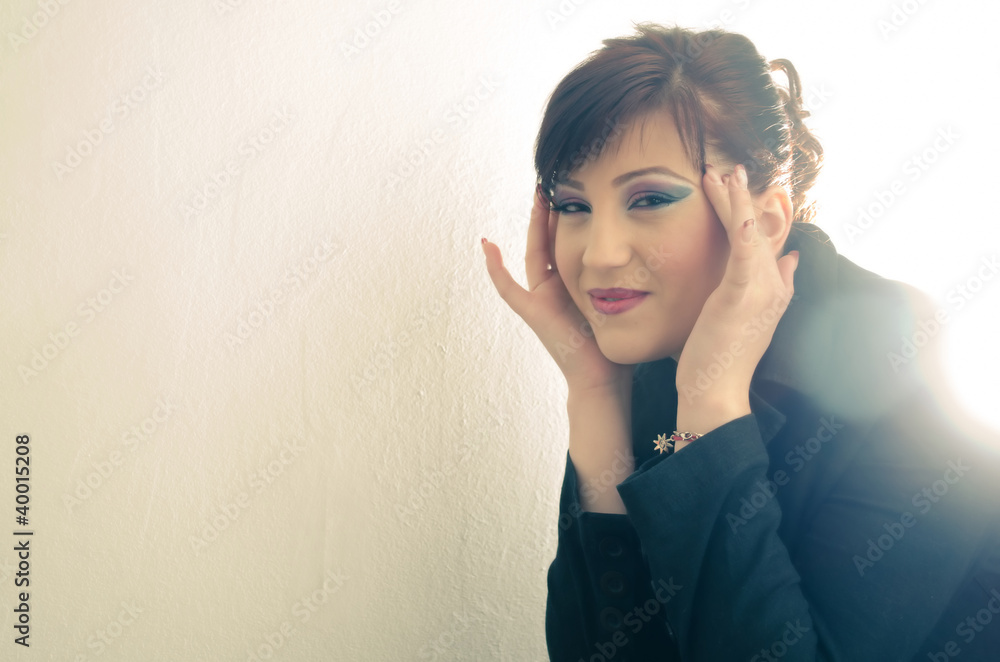Naklejka premium A young attractive woman suffering headache in a bright light