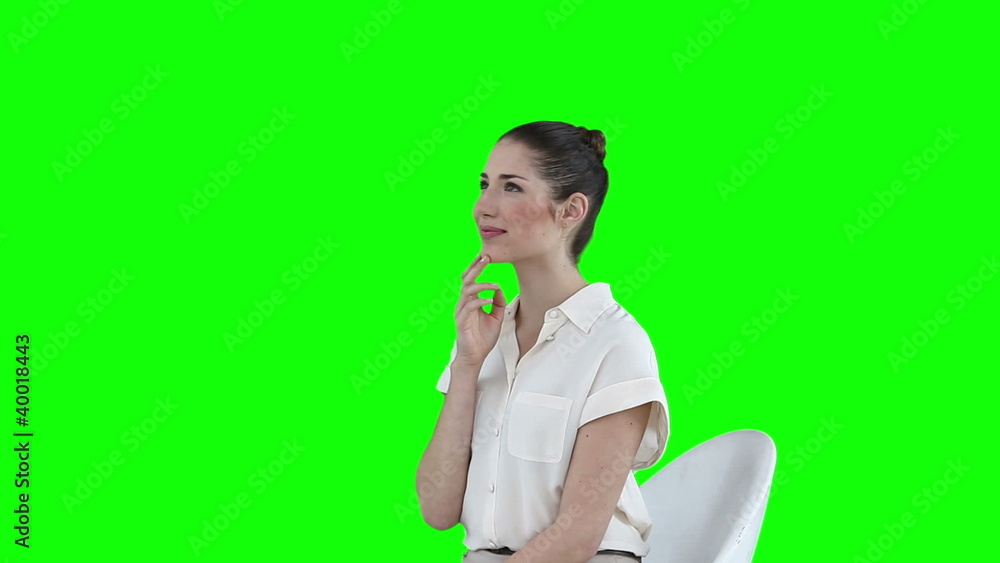 Seated businesswoman using a virtual touchscreen Seated businesswoman using a virtual touchscreen
