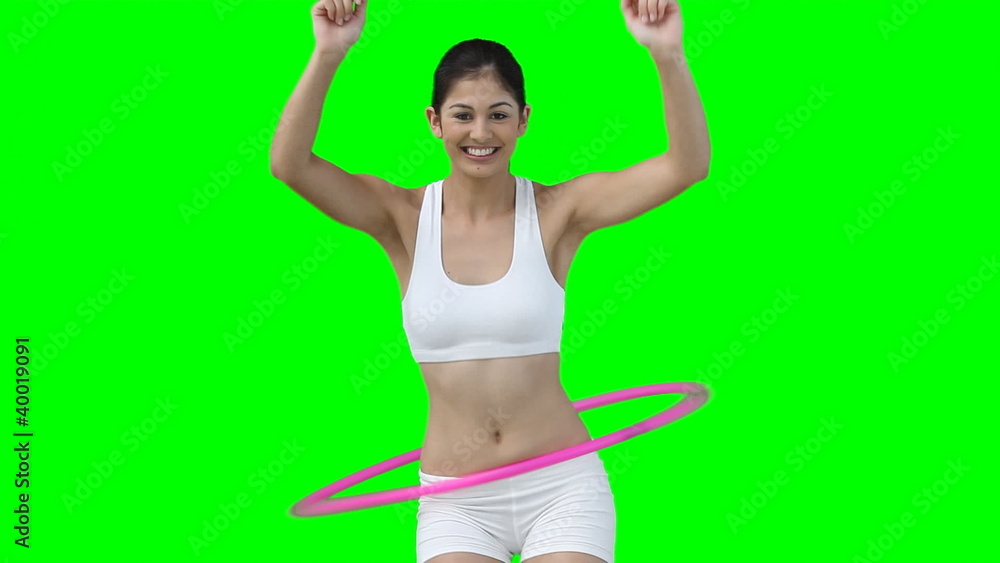 A woman enjoys using a hula hoop A woman enjoys using a hula hoop