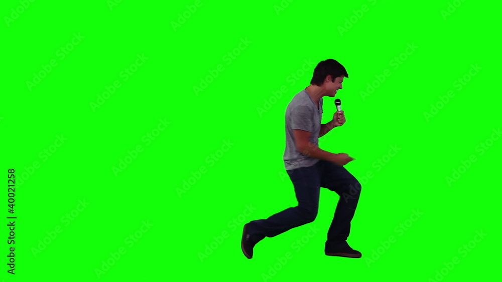 A man is singing into a microphone A man is singing into a microphone