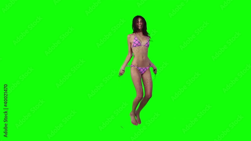 A woman in a bikini is using a skipping rope A woman in a bikini is using a skipping rope