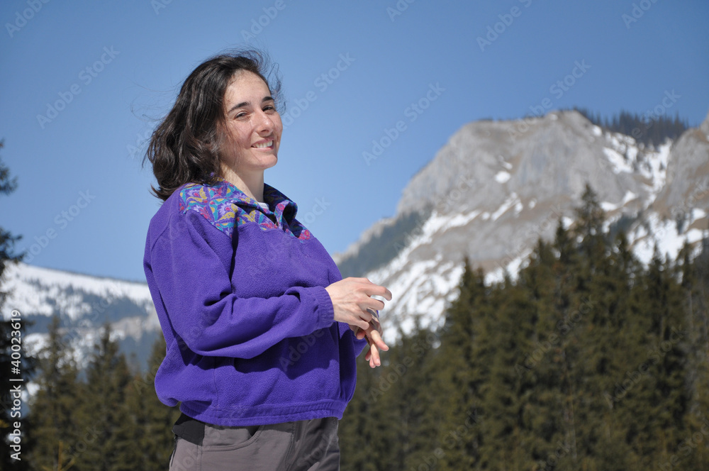 Portrait of a young woman at winter in the mountains
