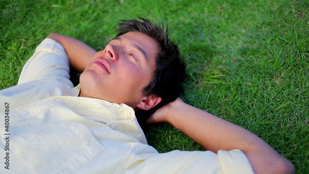 Peaceful man sleeping on the grass Peaceful man sleeping on the grass