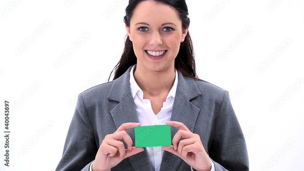 Smiling brunette woman holding a business card Smiling brunette woman holding a business card
