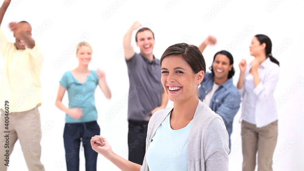 Woman with friends jumping behind her Woman with friends jumping behind her