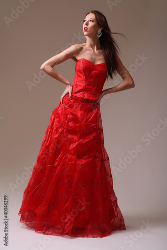 Young fashion model in red dress
