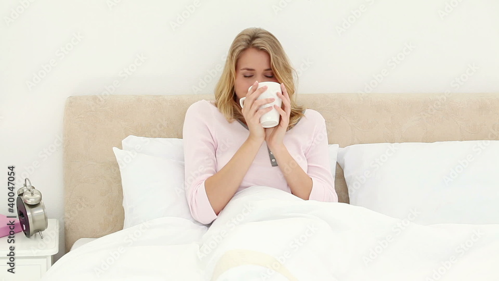Smiling blonde woman drinking a tea Smiling blonde woman drinking a tea