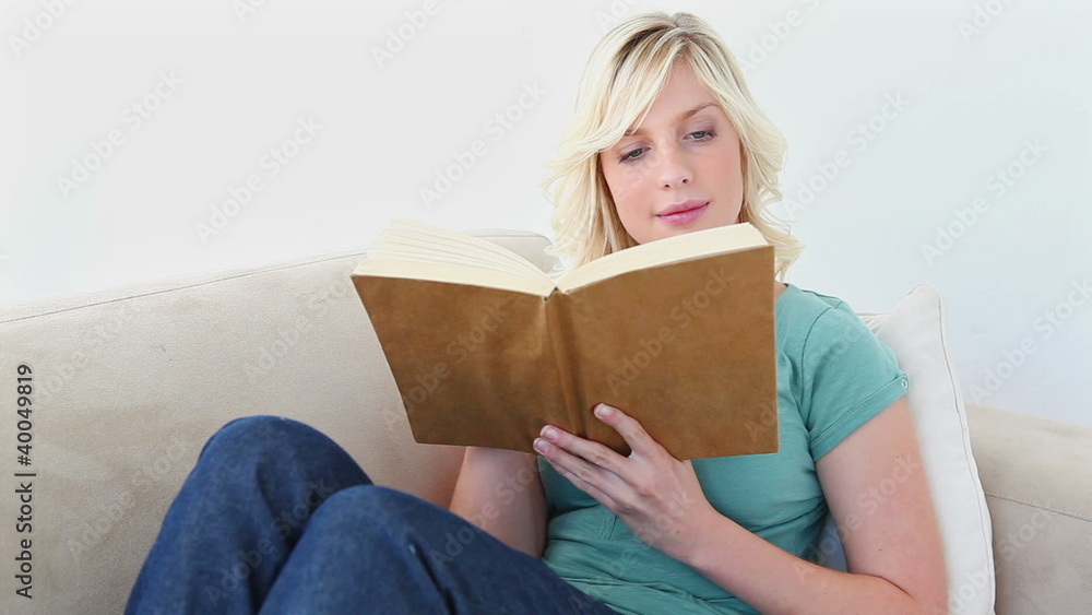 Blonde haired woman reading a book Blonde haired woman reading a book