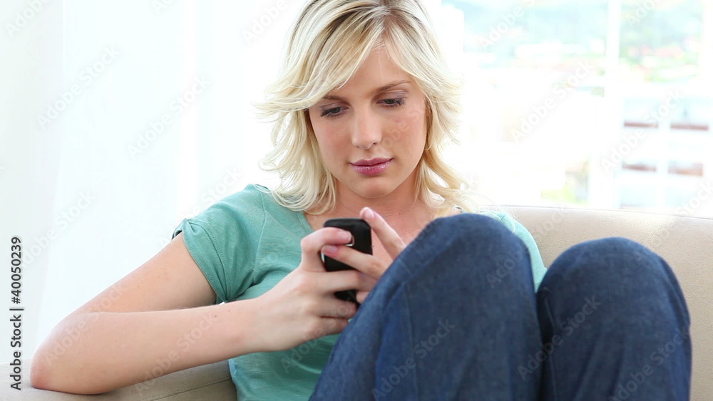 Young blonde woman sending text message Young blonde woman sending text message