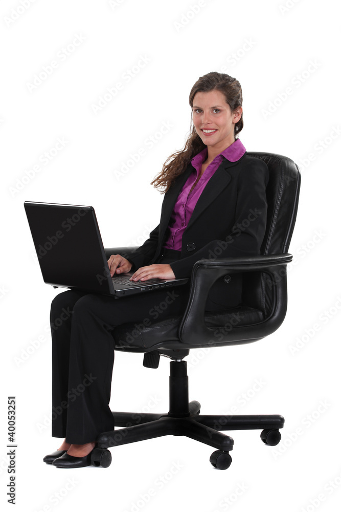 Female office worker sitting with laptop Female office worker sitting with laptop