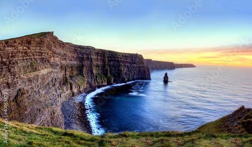 Fotografia, Obraz Panoramic view of Cliffs of Moher at sunset in Ireland.