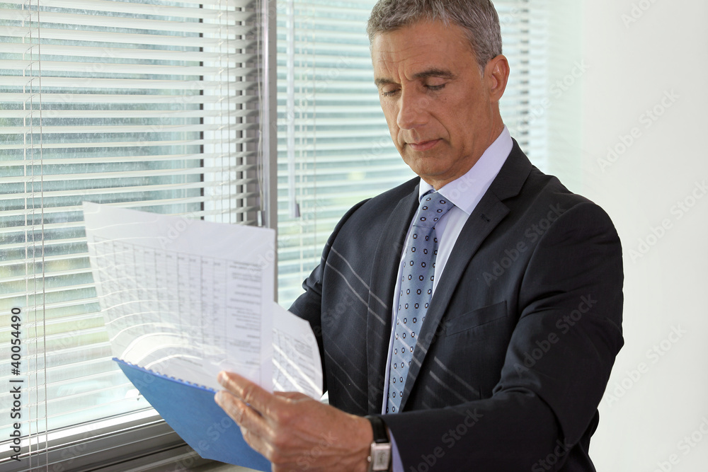 Senior businessman going over important documents Senior businessman going over important documents