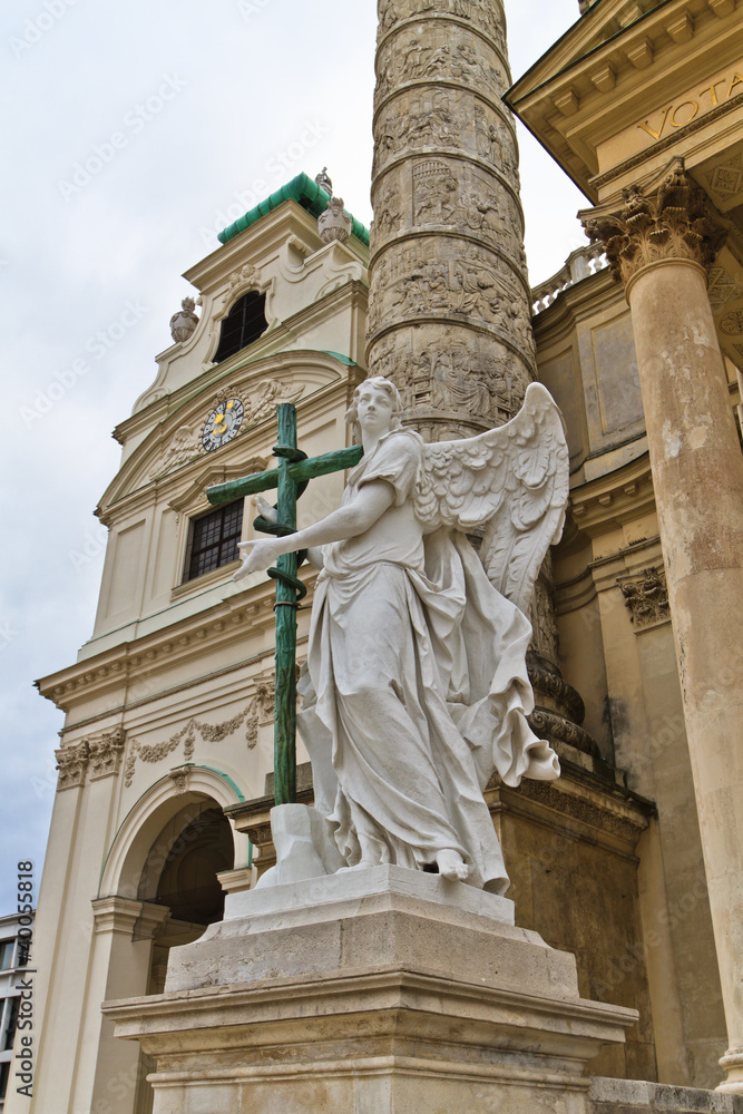 Angel statue with cross in front of Karlskirche (St. Charles's C