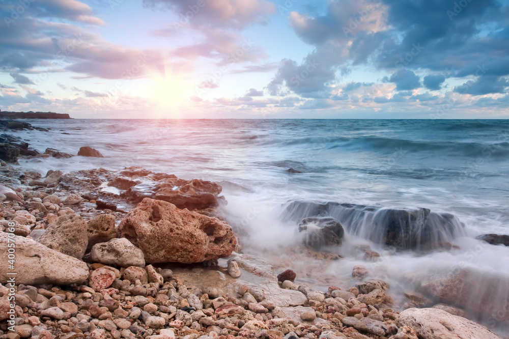 Fototapeta premium Beautiful rocky sea beach at the sunset
