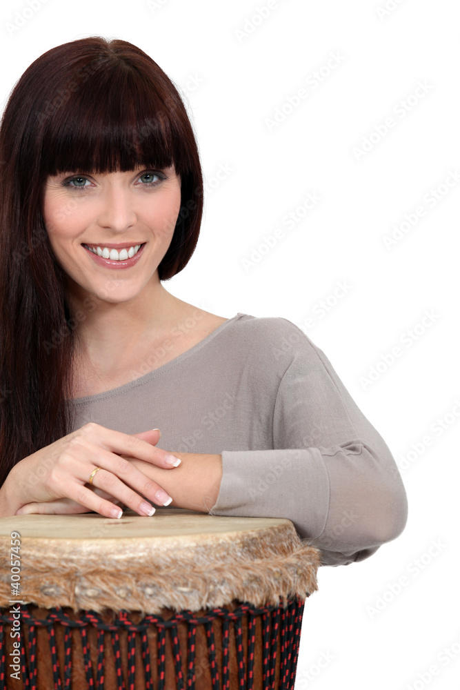 Brunette playing bongo drum