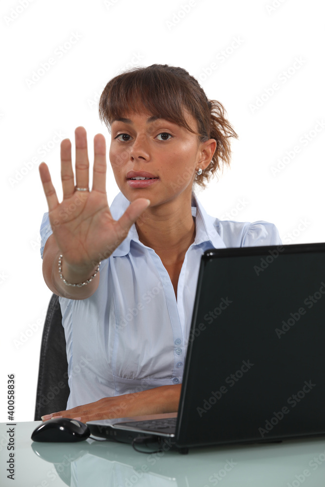 Businesswoman holding out hand in stop gesture Businesswoman holding out hand in stop gesture