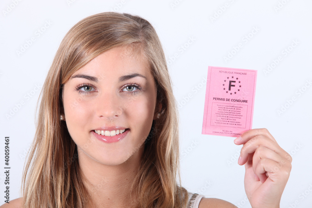 Blonde girl showing driving license Blonde girl showing driving license