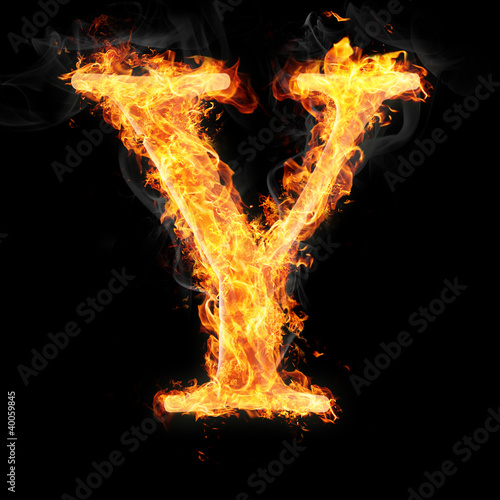 Fonts and symbols in fire on black background - Y