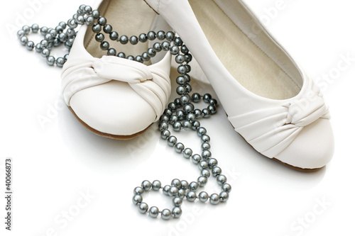 White ladies shoes with silver pearl necklace