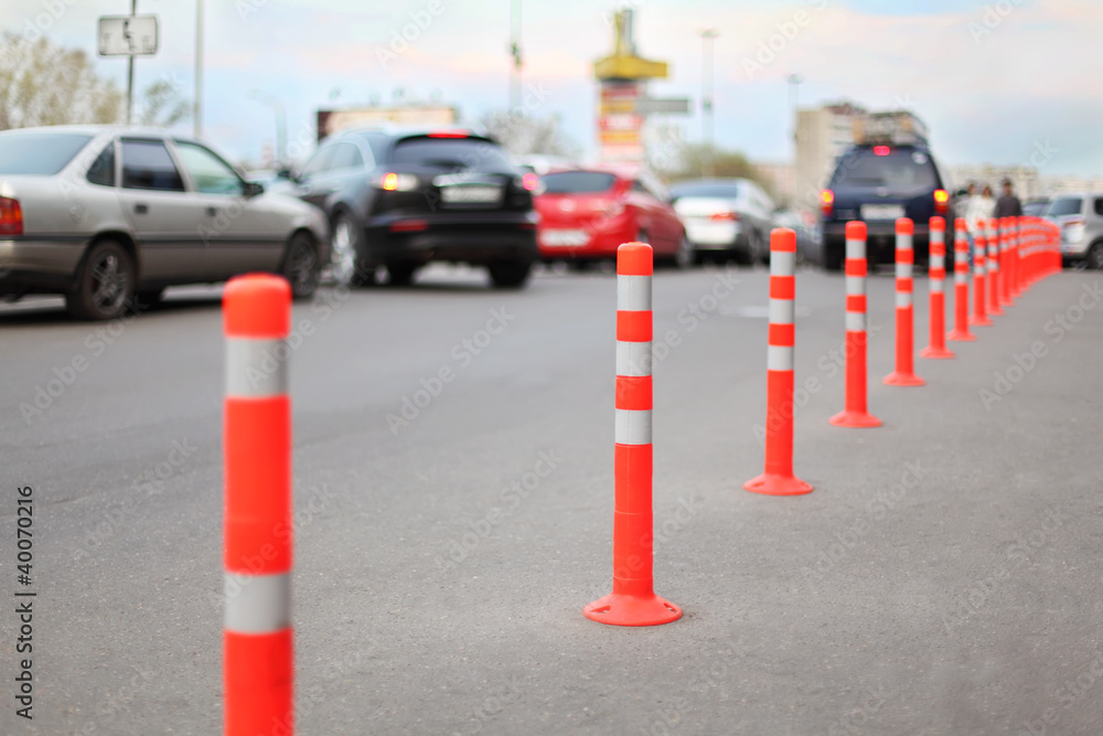 protective barrier made of red striped columns on road protective barrier made of red striped columns on road